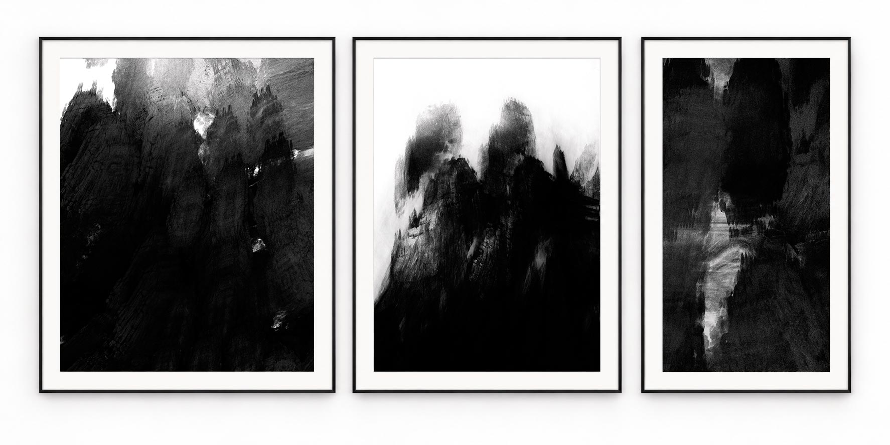 Three monochrome abstract paintings with black, silver and white textures, in black frames