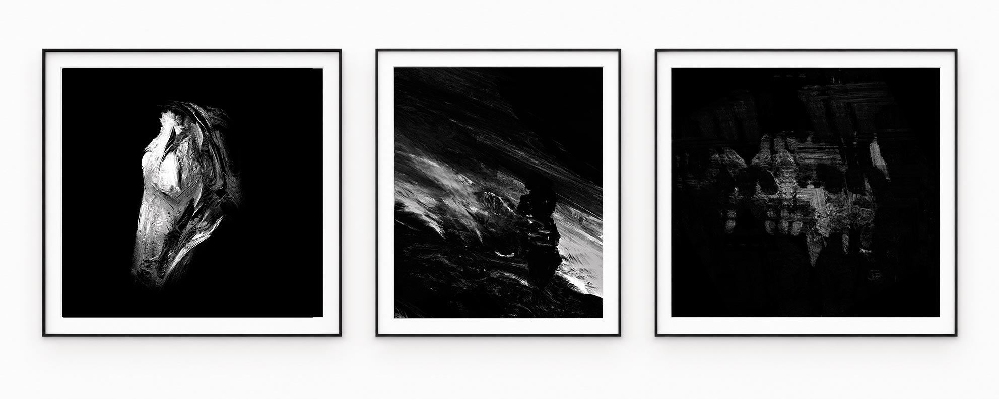 Three silver and graphite forms on black backgrounds, in black frames with white mounts