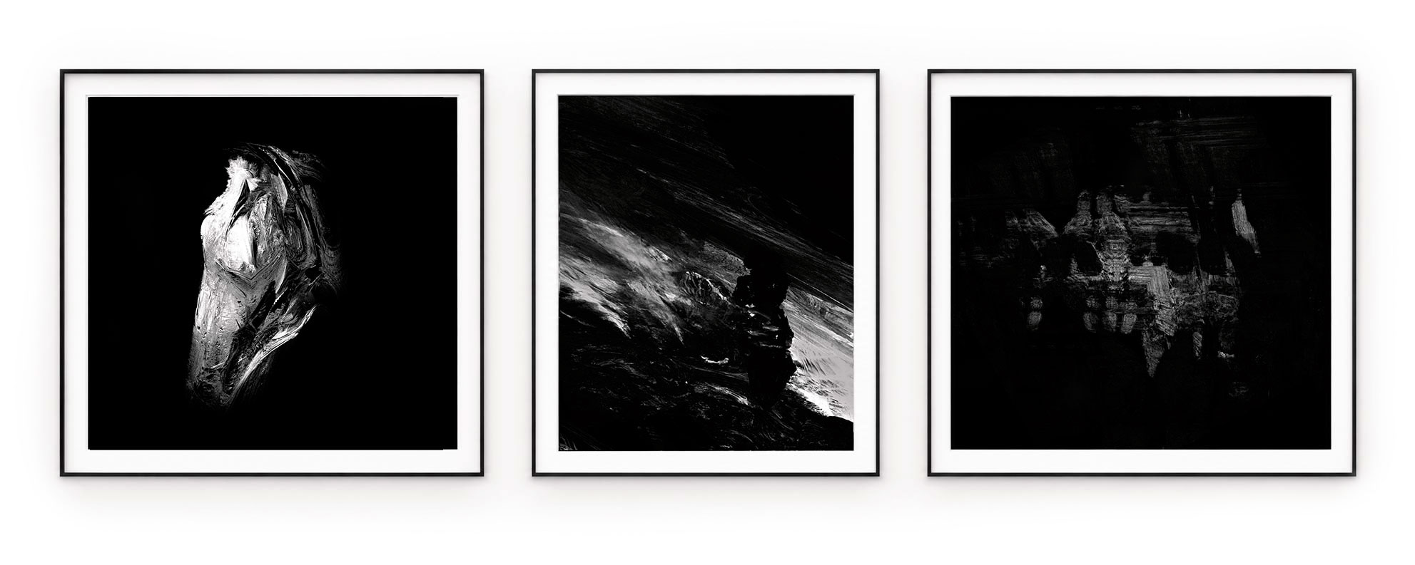 Three silver and graphite abstract forms on black backgrounds, in black frames with white mounts